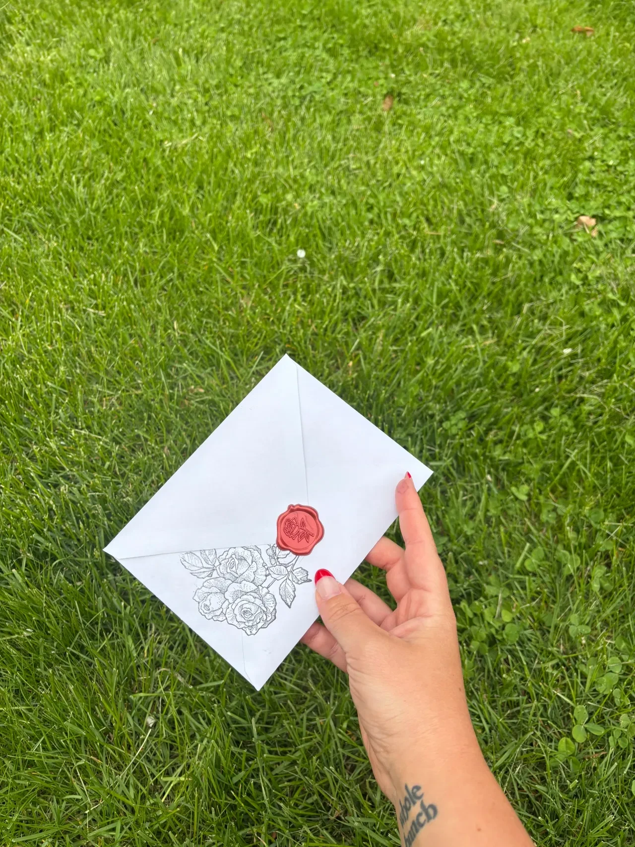 Rows of hand-stamped rose letters bundled with ribbon, candle and incense in background