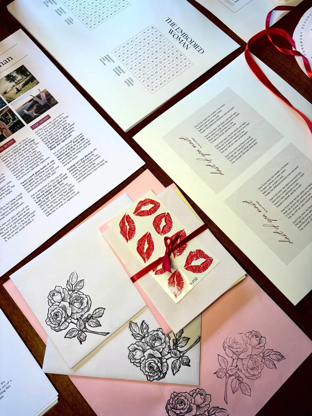 Monthly letter contents spread on a table — rose illustrations, lip prints, and handwritten pages